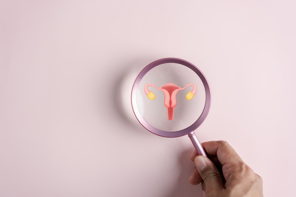 diagram of uterus and ovaries under magnifying glass